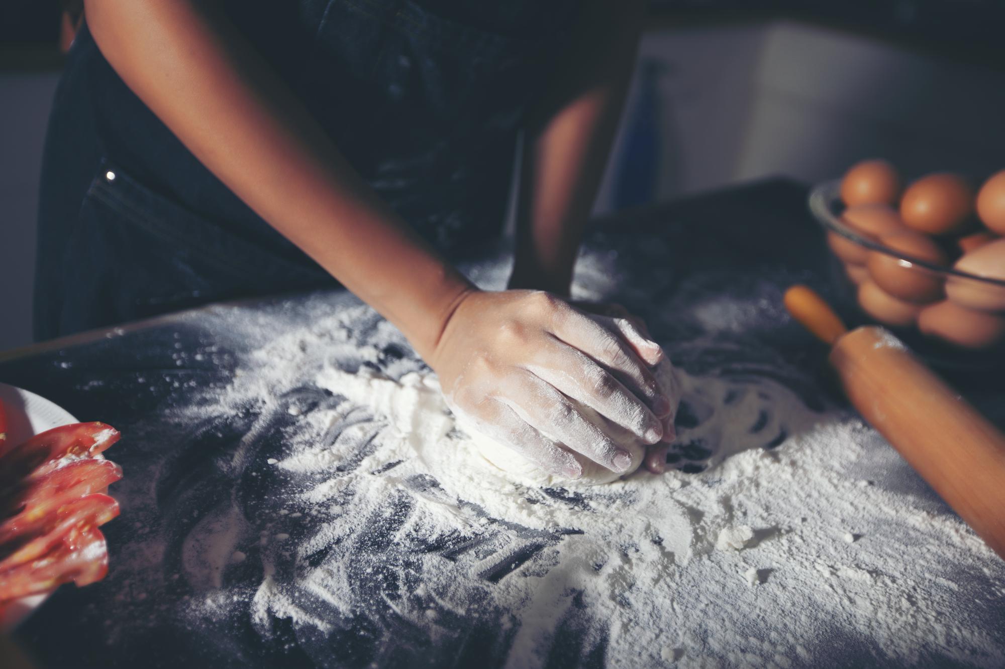 Workshop hands shaping dough in studio