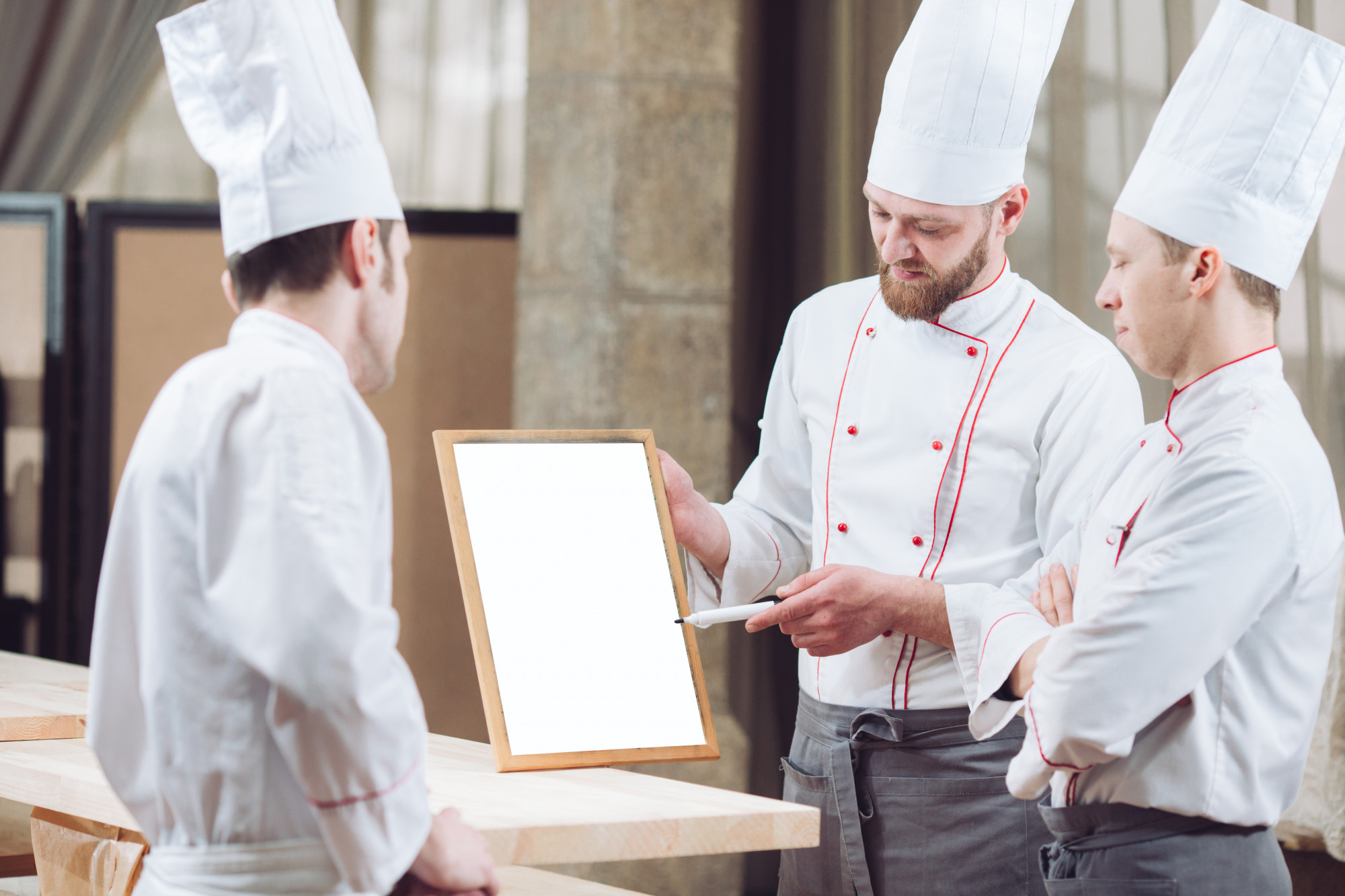 Chef with tasting menu at bench